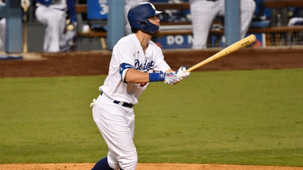 Sep 23, 2020; Los Angeles, California, USA; Los Angeles Dodgers center fielder Cody Bellinger (35) watches his solo homer clear the fence in the seventh inning against the Oakland Athletics at Dodger Stadium. Mandatory Credit: Robert Hanashiro-USA TODAY Sports
